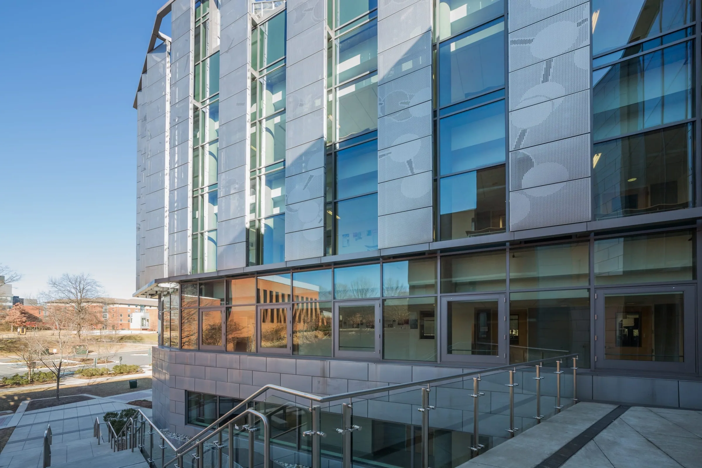 The building’s glass and steel corner over a sunken courtyard