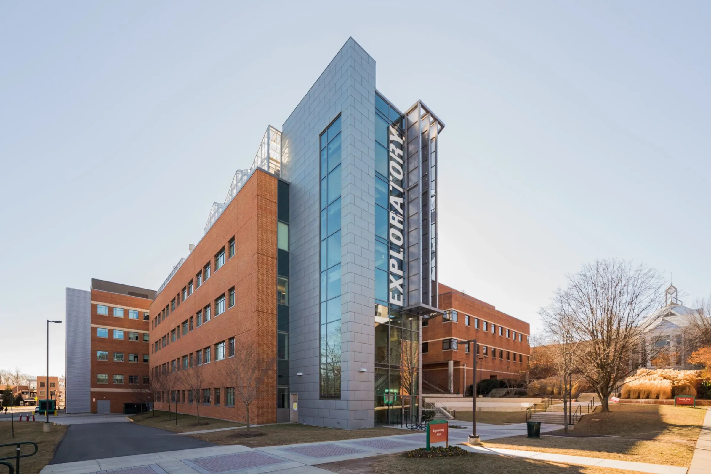 Exploratory Hall’s glass and perforated steel tower beside the brick campus