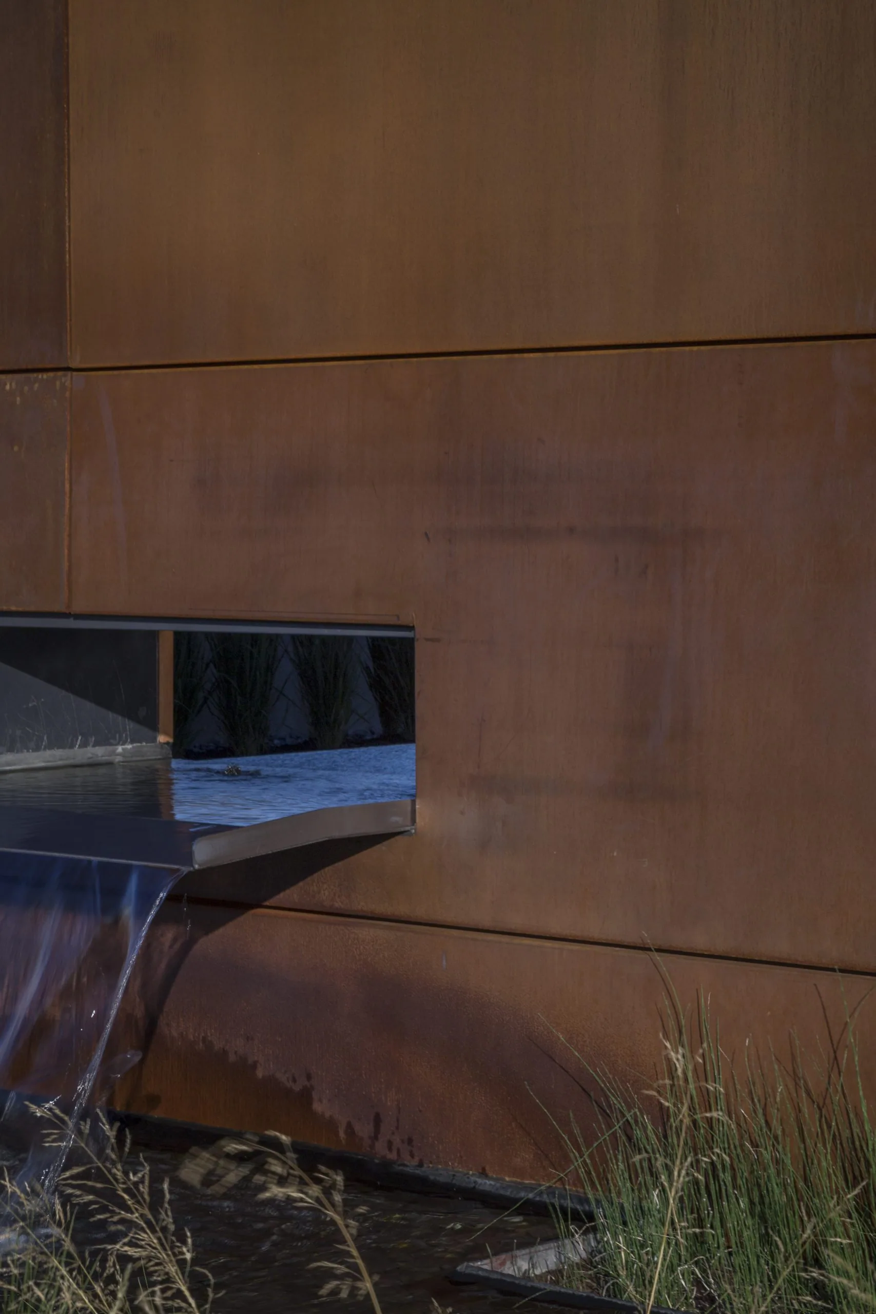 A preweathered steel wall panel by the entrance