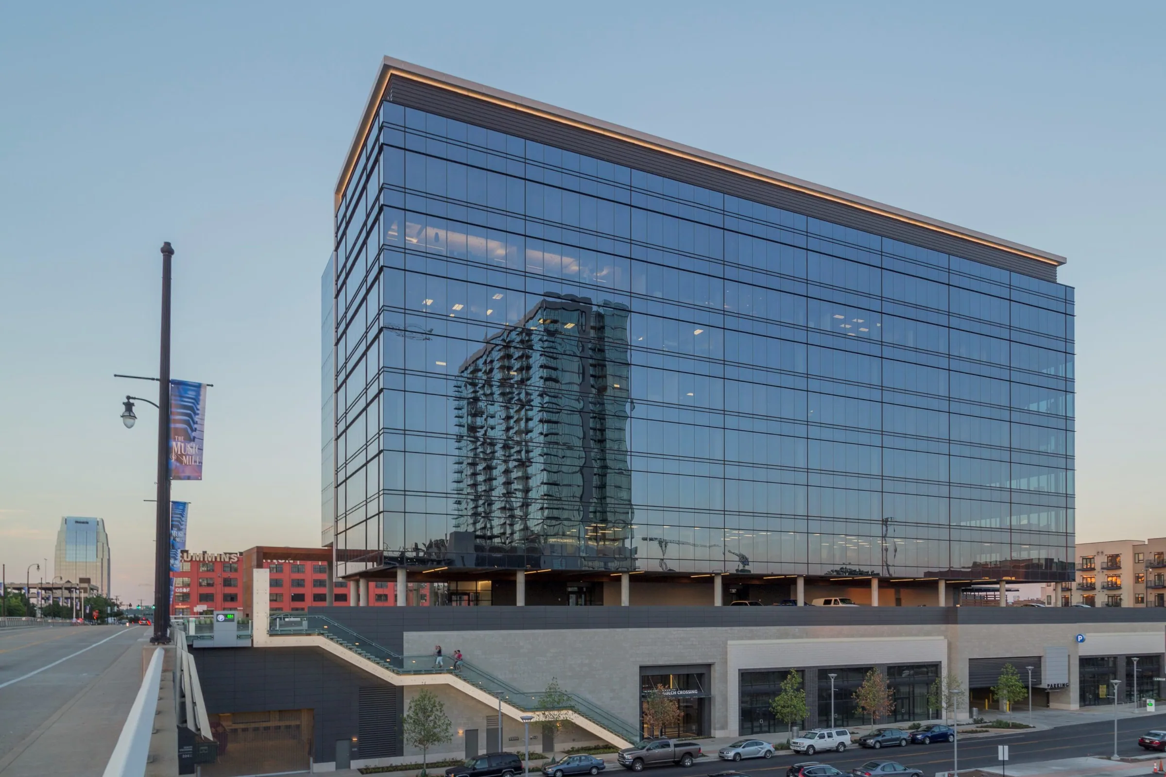 Gulch Crossing’s glass tower above the street at sunset
