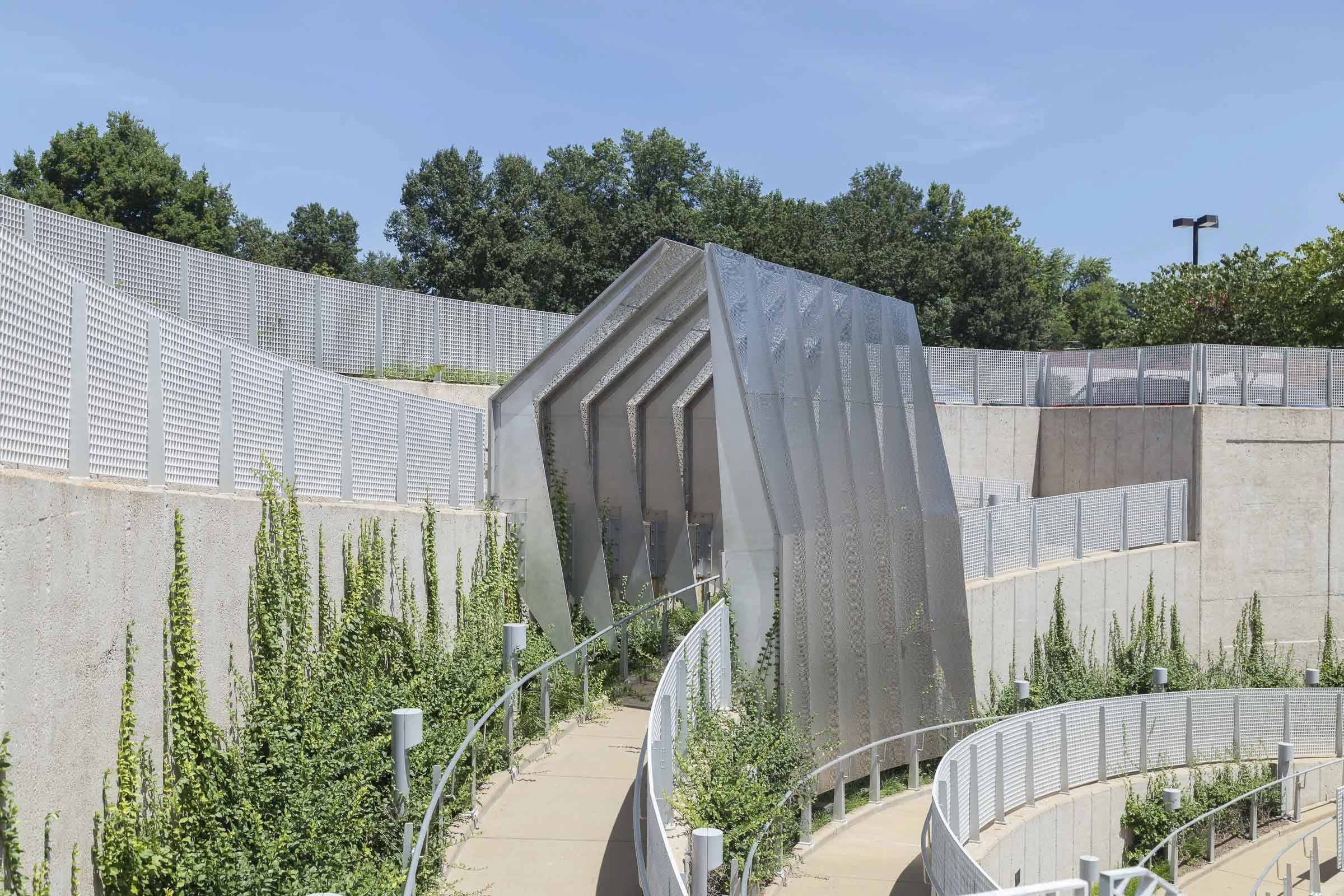 Perforated panels bending along the curved station wall