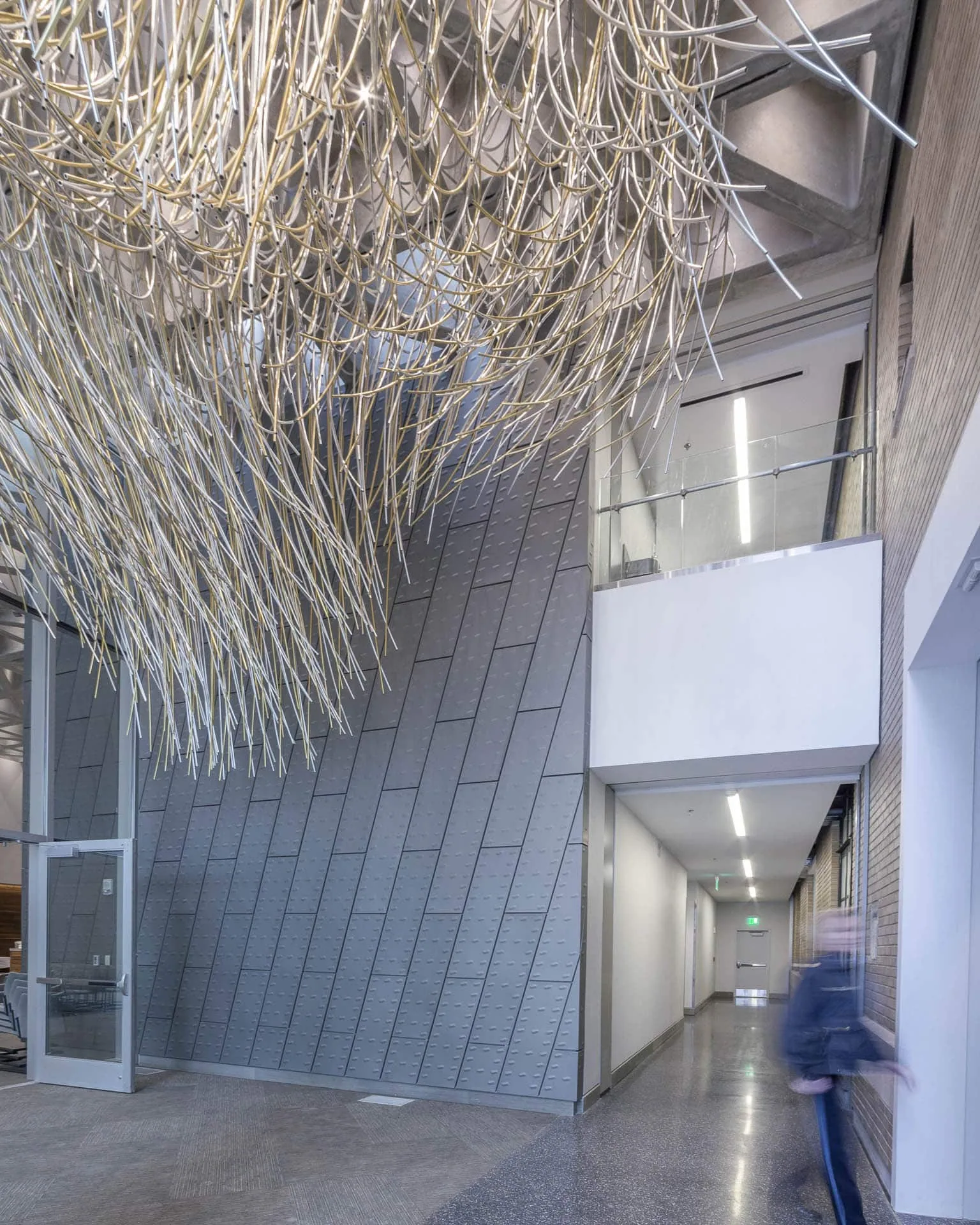 The hanging sculpture above a lobby lined in zinc