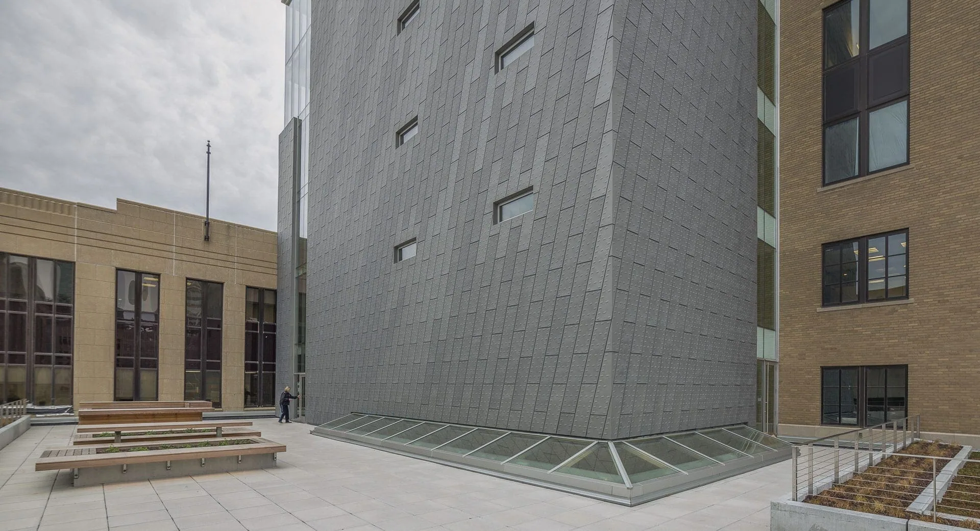 The zinc-clad building beside older brick neighbors