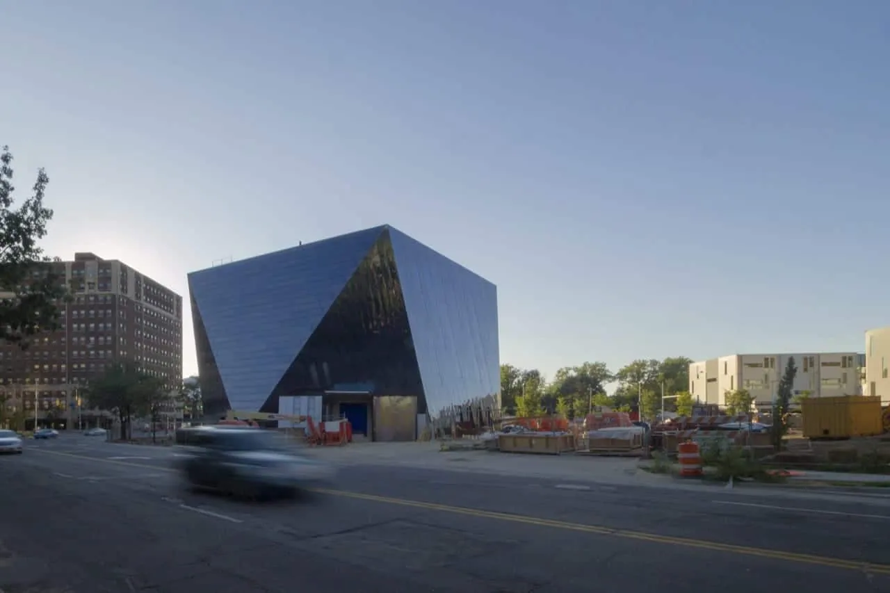 The museum from across the street as a car passes