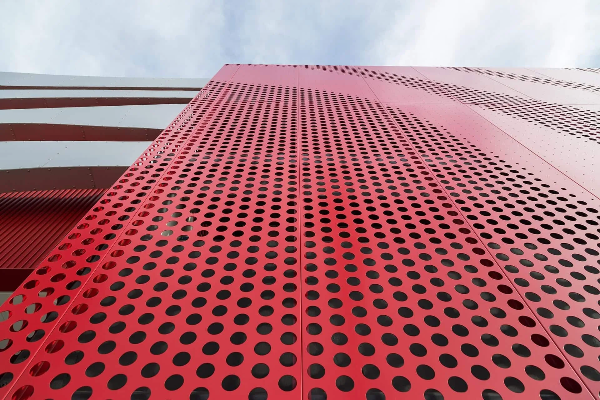 Looking up the red perforated skin of the garage