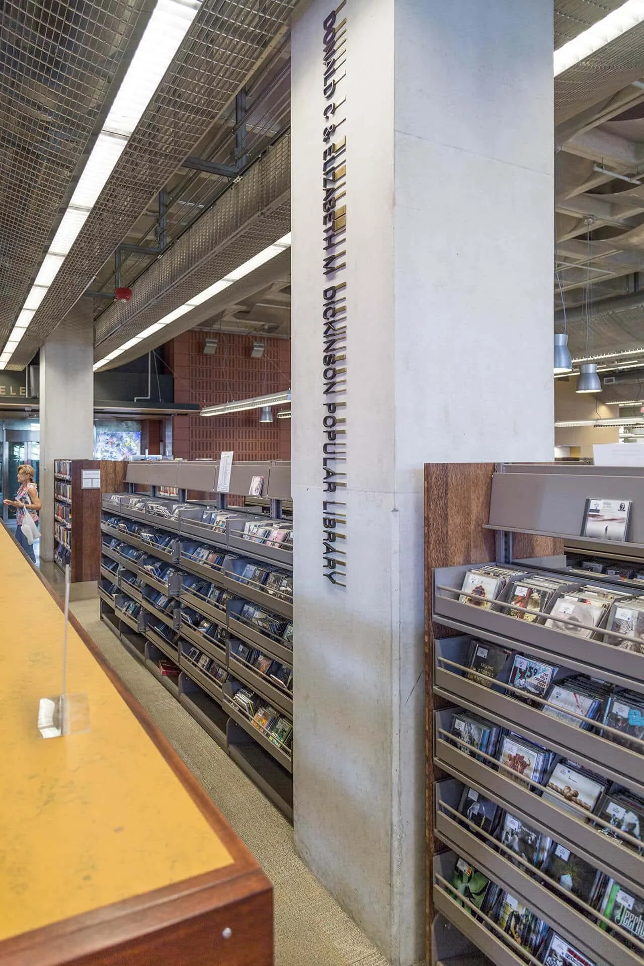 A lettered column among the library shelves