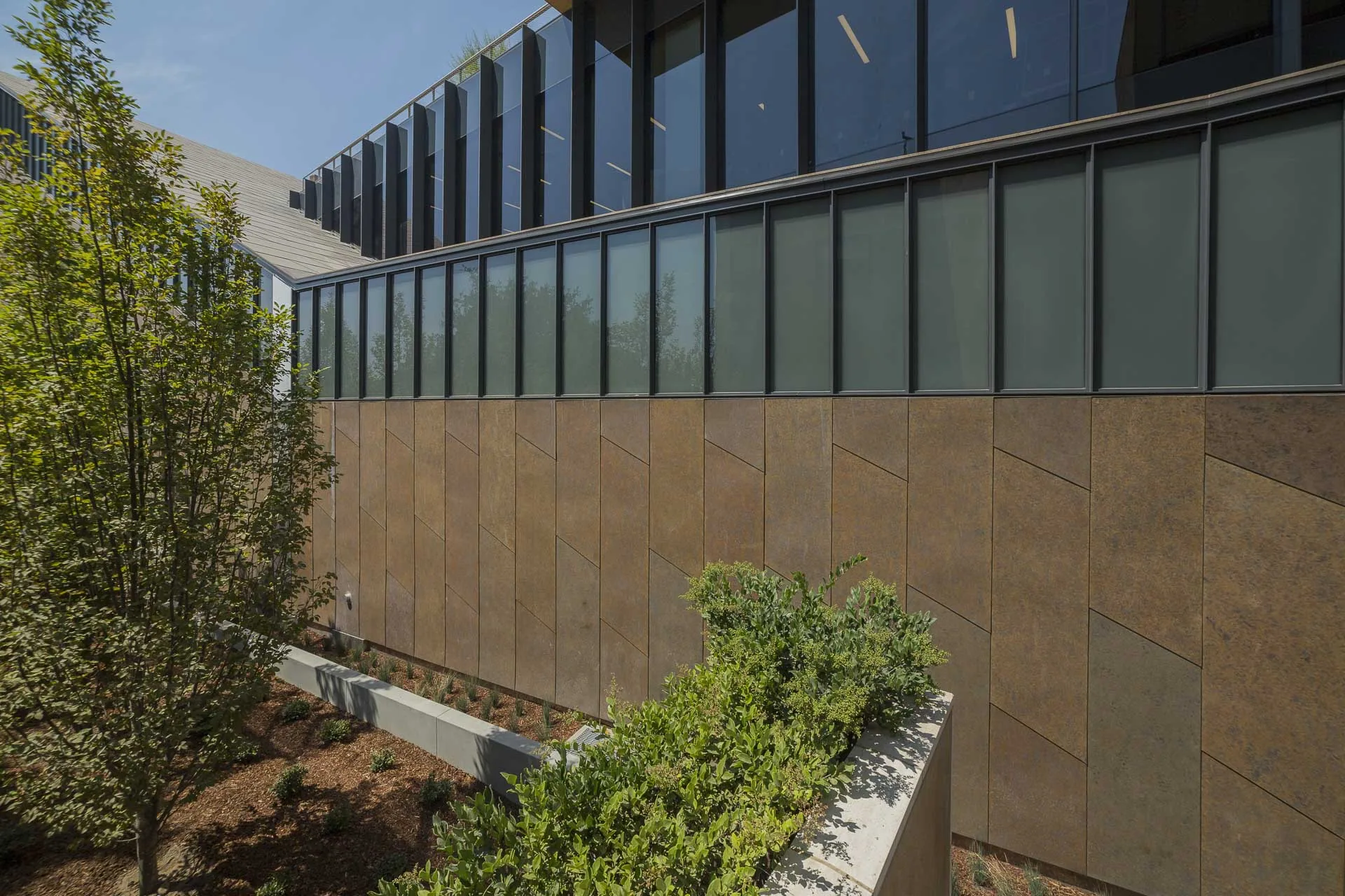 A long zinc wall under a strip of clerestory windows