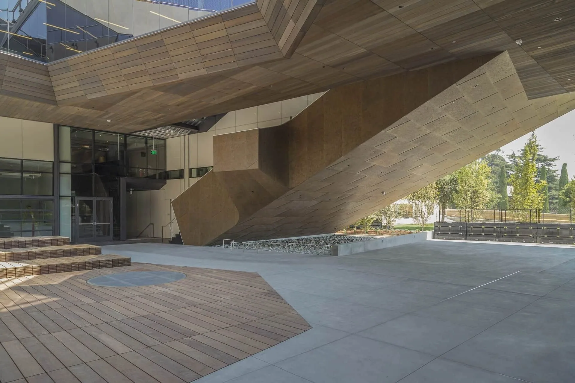 Zinc soffits folding over an outdoor gathering space