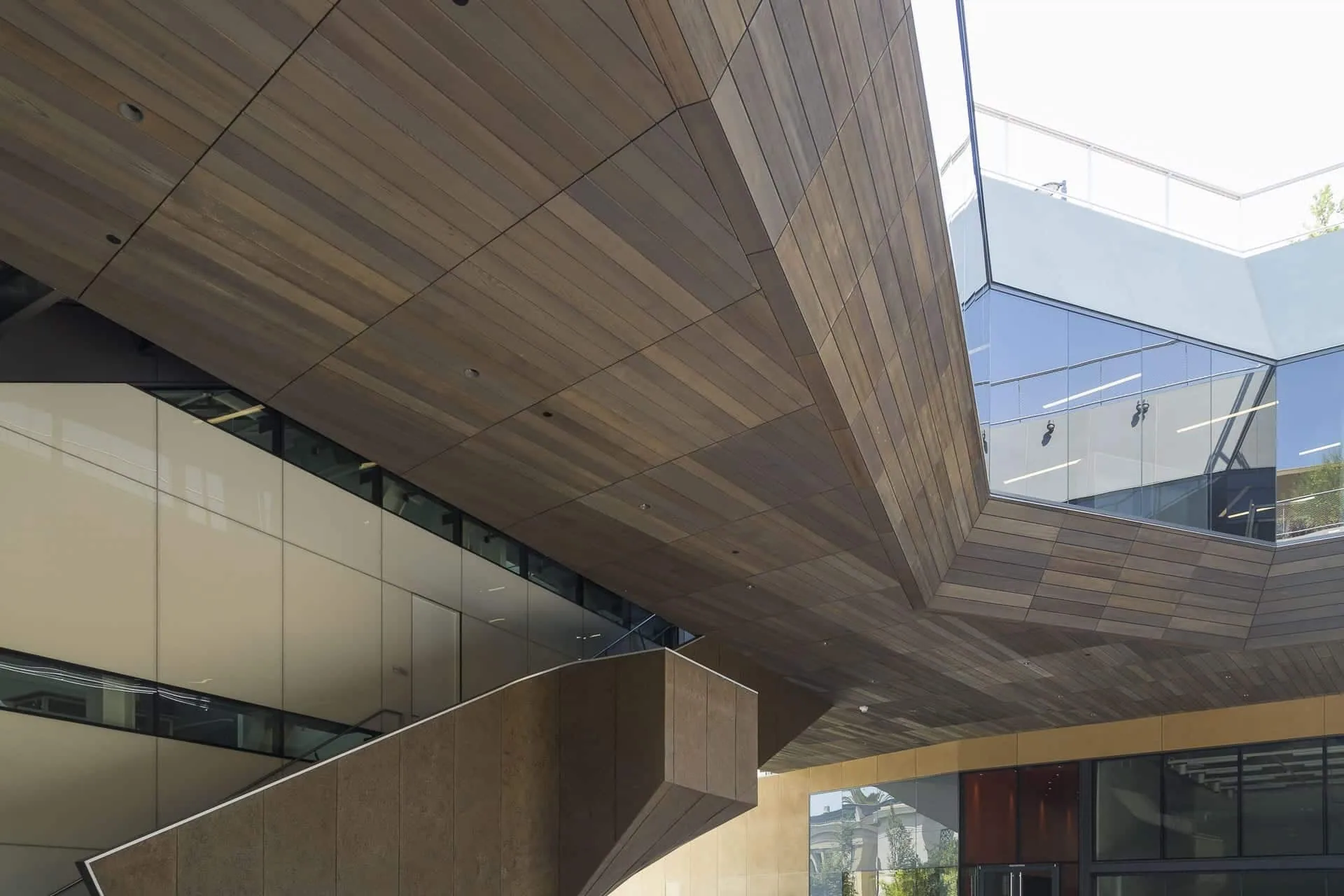 Looking up at a zinc soffit as it turns into the wall