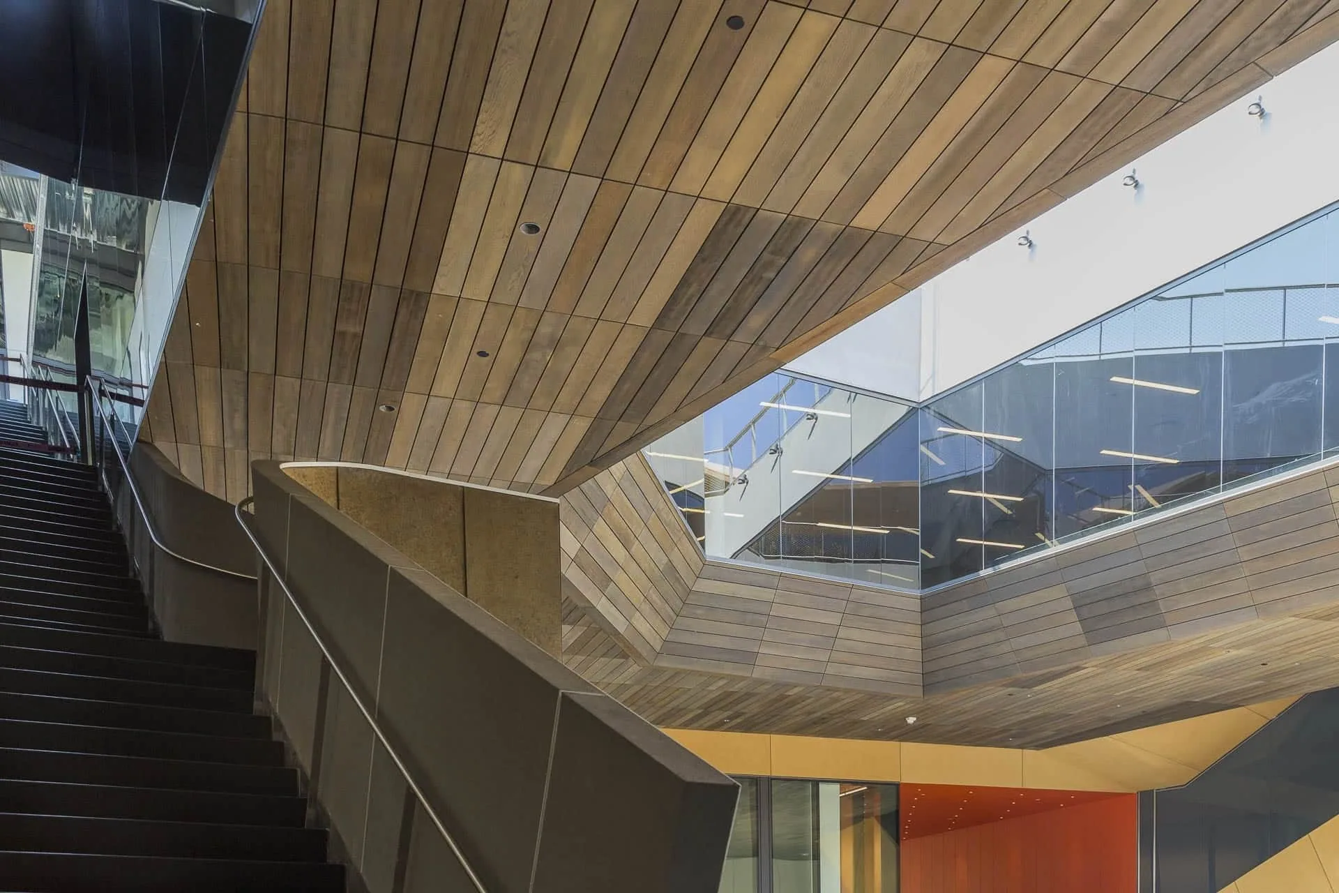 A stair climbing under the zinc-clad underside of a wing