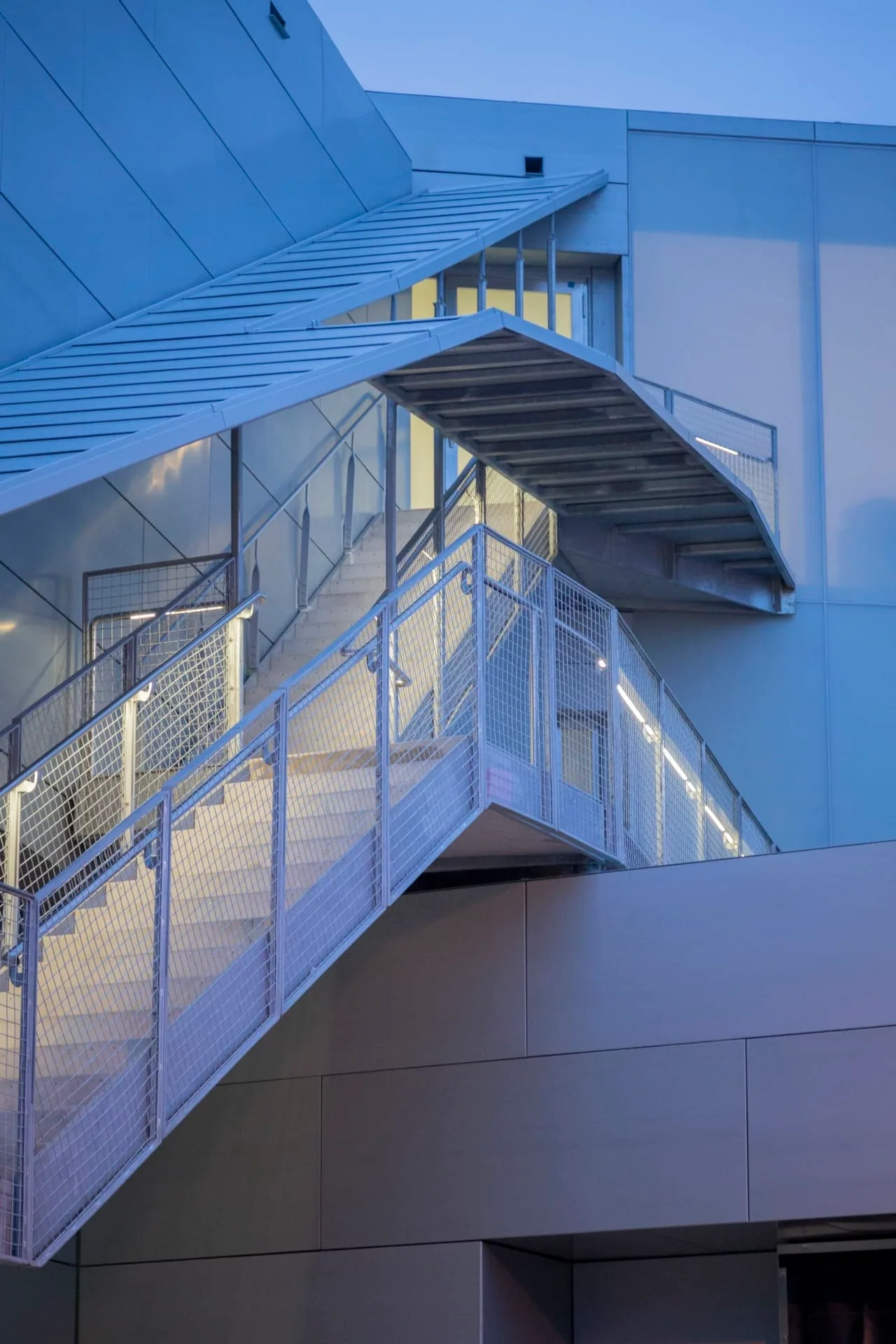 A stair canopy cantilevered from the zinc walls