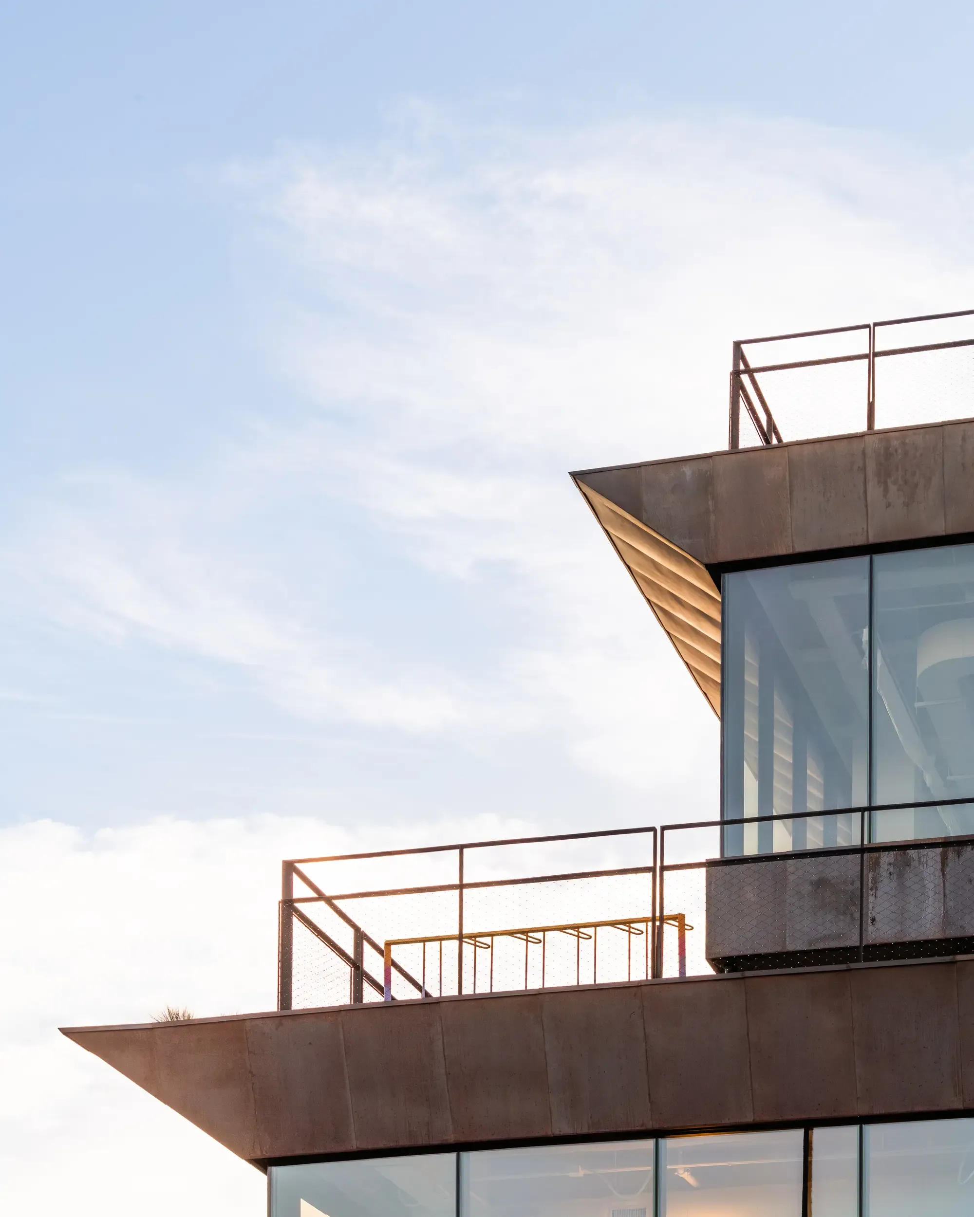 A railing at the tip of a copper-edged terrace