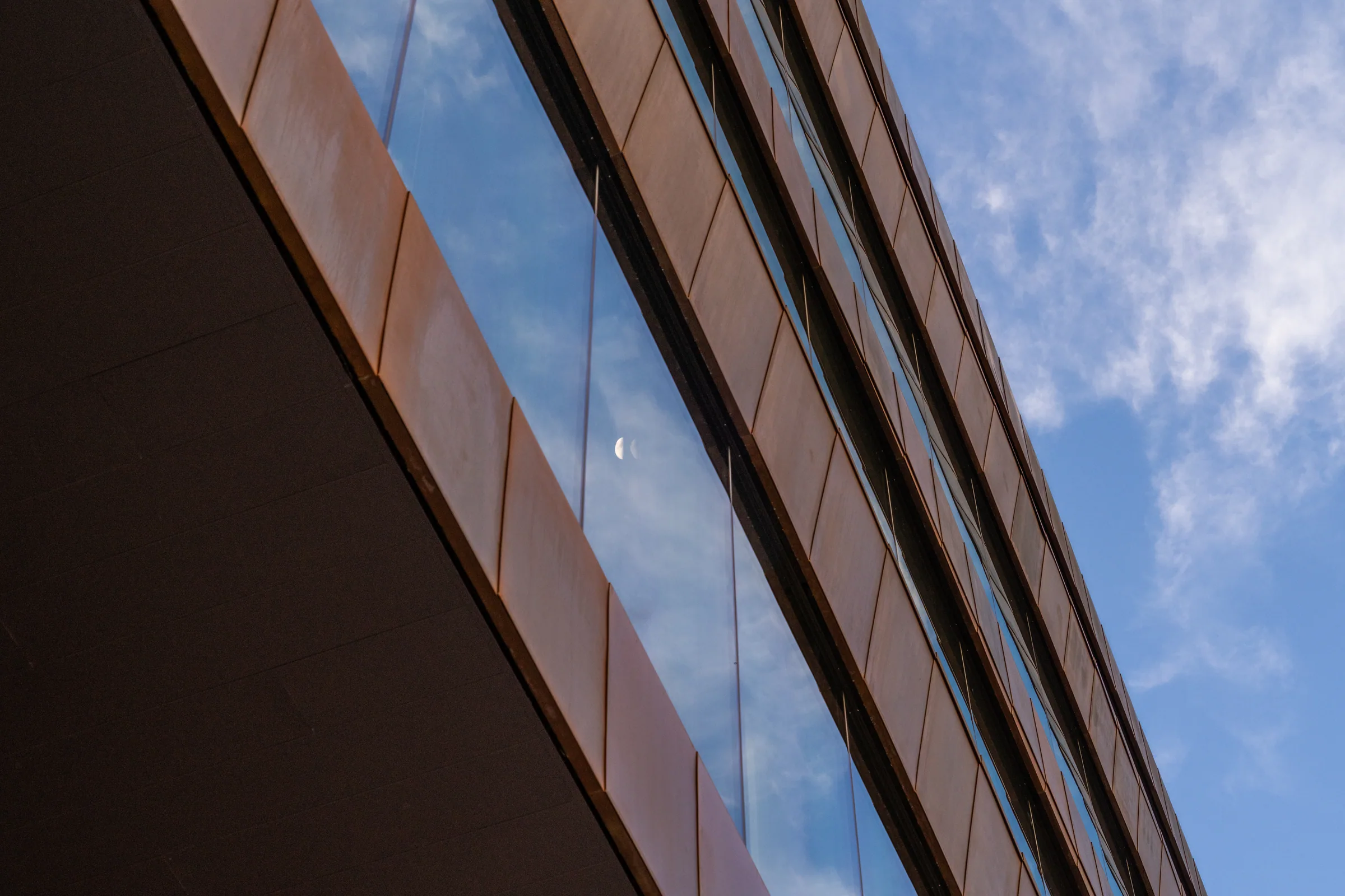 The copper ramp edge cutting diagonally across the glass