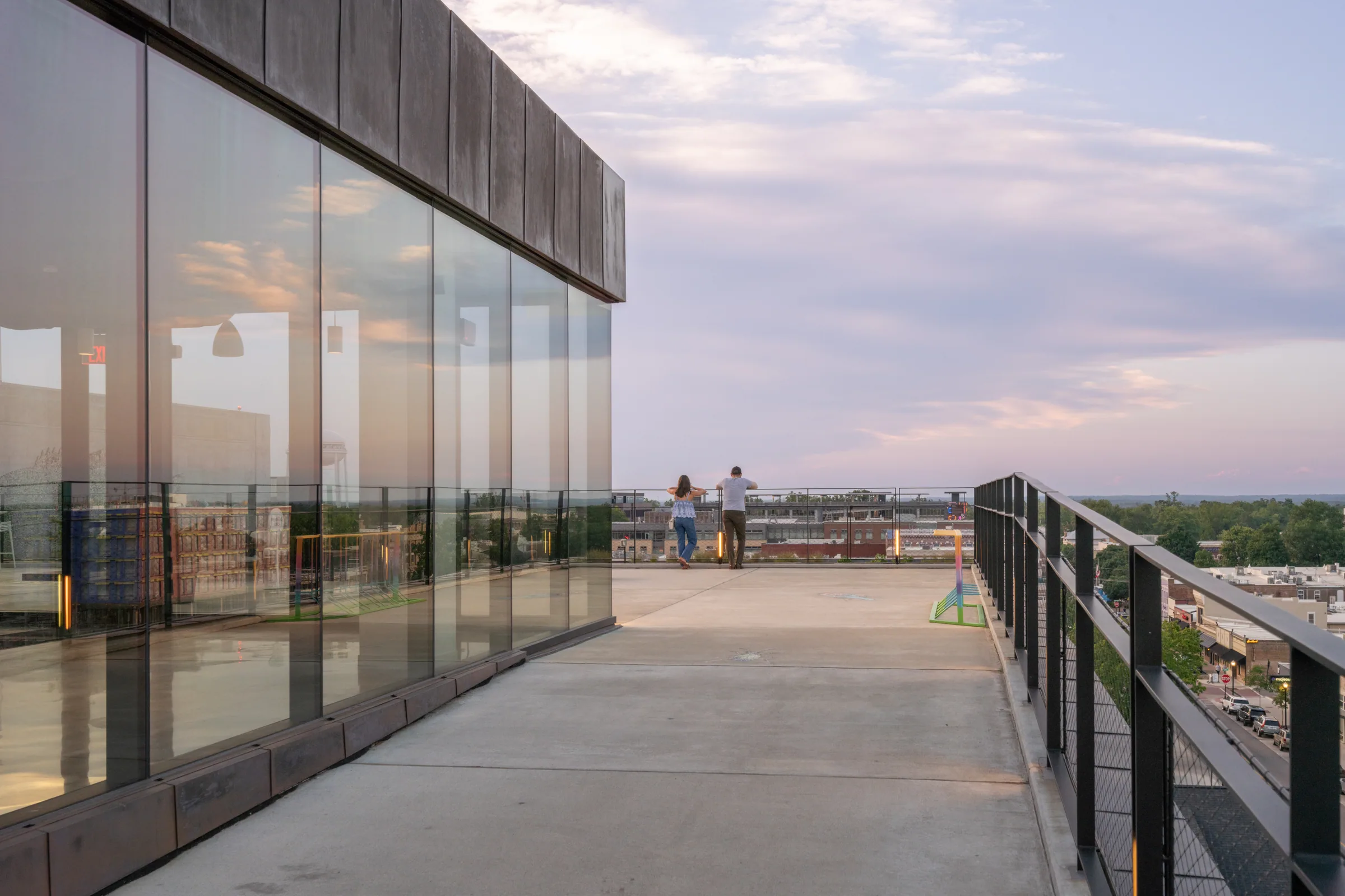 People on the open-air ramp beside the glass