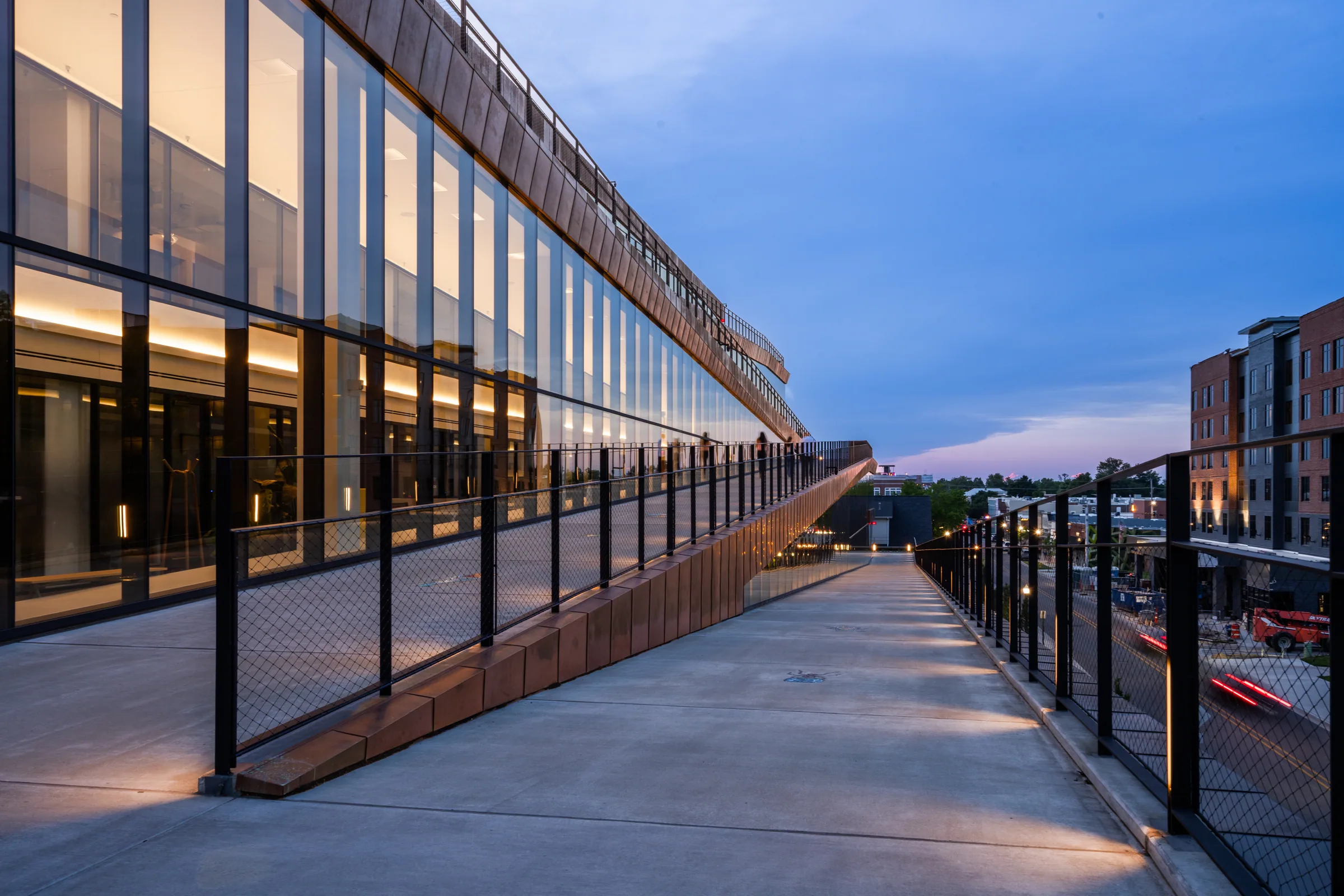 The ramp climbing beside the glass at dusk